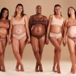 pregnant-women-portrait-holding-hands-support-body-empowerment-studio-background-community-happy-smile-pregnancy-friends-underwear-belly-growth-diversity-pride-mothers-day_590464-135905